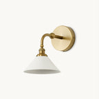 Brass Clérachic wall light with a curved arm, a round backplate and a white conical shade, shown on a plain white backdrop.