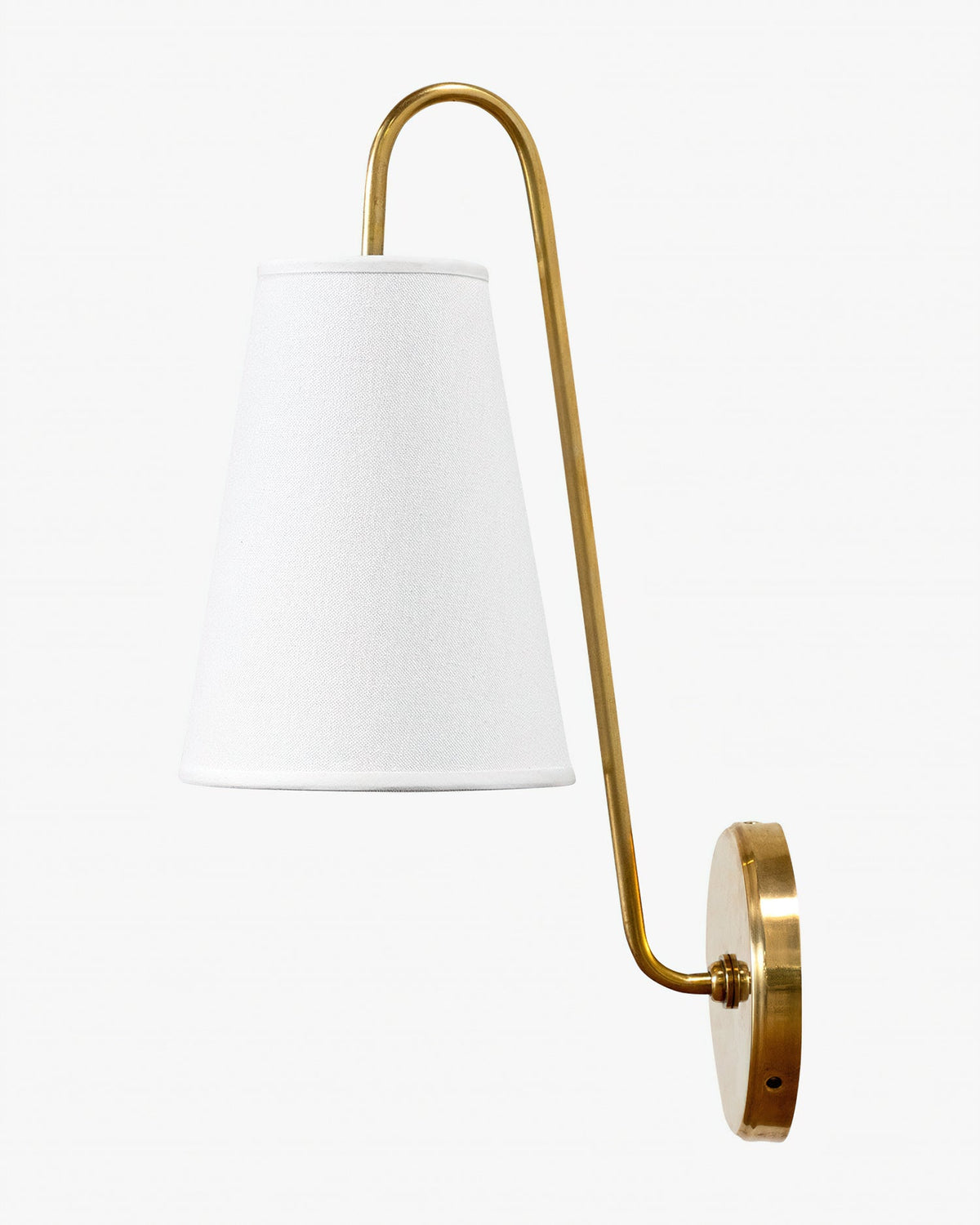 Brass Clérachic wall light with a white tapered fabric shade and a curved arm, seen at an angle on a pale background.