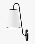 A black Clérachic wall light with a white tapered shade trimmed in black, on a curved arm, on a pale background.