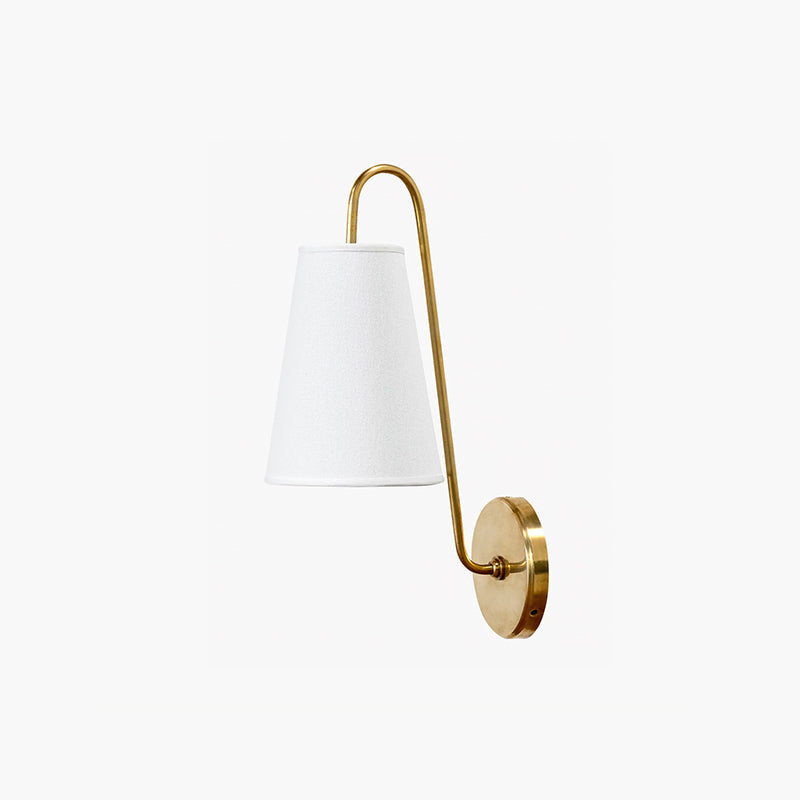 Front view of a brass Clérachic wall light with a white tapered shade and a round backplate, on a light background.
