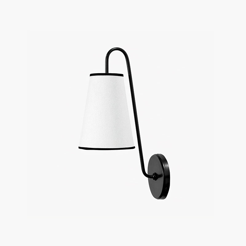 Front view of a black and white Clérachic wall light, with a black-trimmed white shade on a curved black arm.