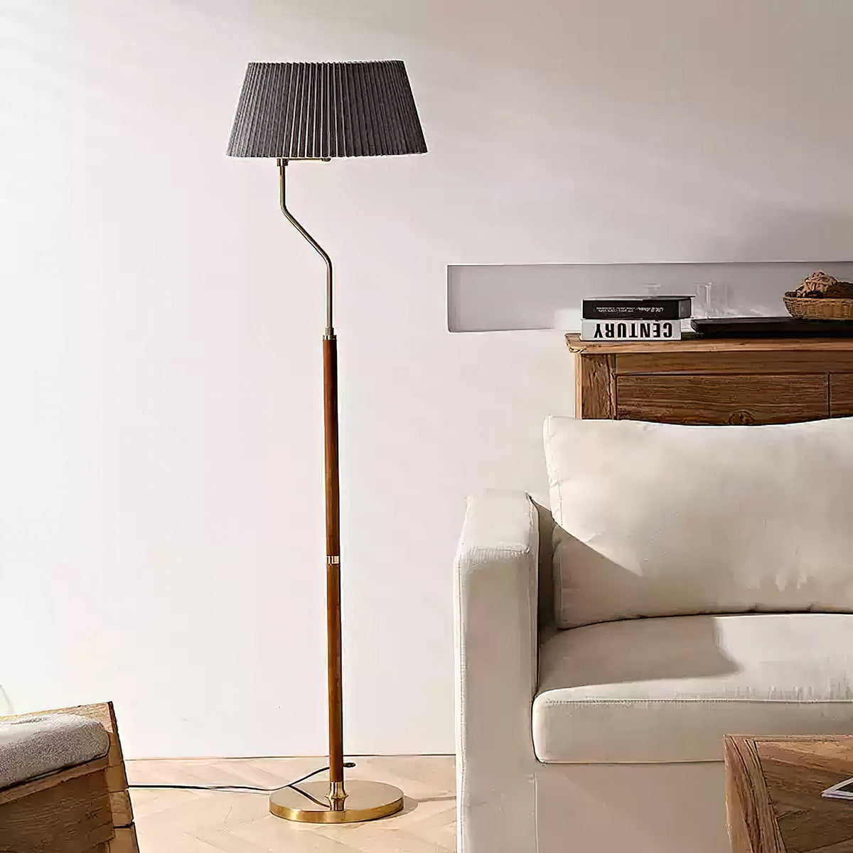 Dark grey pleated shade on a Clérachic floor lamp with a walnut stem, standing by a cream armchair and wood sideboard.