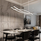 Clérachic black crossing-bar LED chandelier on white cords over a marble-top dining table with dark chairs in a living space.