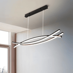 Clérachic black crossing-bar LED chandelier on a black canopy, glowing in a bright room beside a tall window.