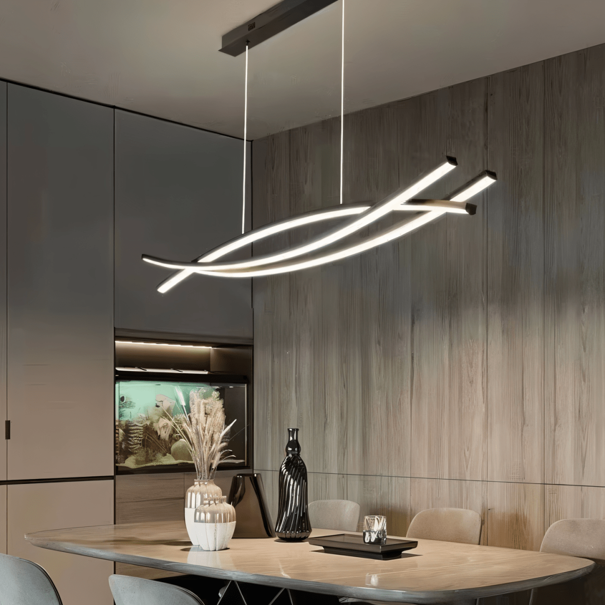 Clérachic black crossing-bar LED chandelier on white cords over a dining table, with a wood-panelled wall behind.