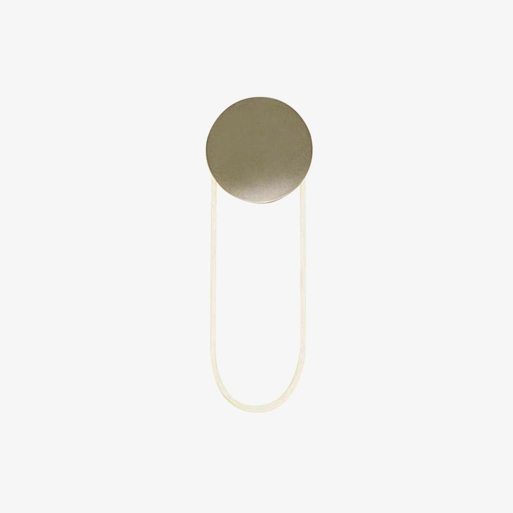 Gold disc and a soft, pale LED loop on this Clérachic wall light, shown unlit on a plain white backdrop.