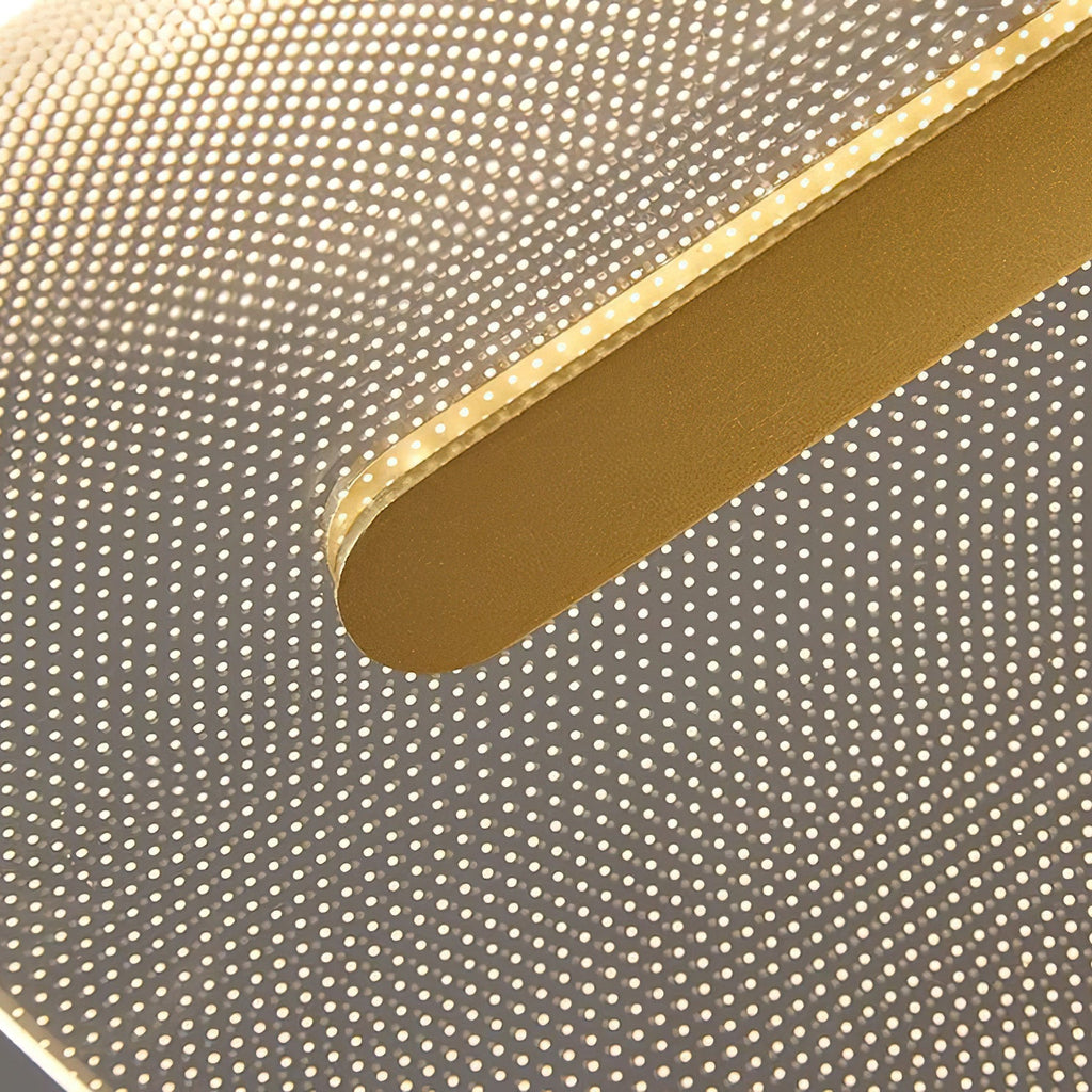 Close view of the gold bar end against the lit acrylic shade of this Clérachic pendant, with its fine pattern of dots.