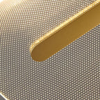 Close view of the gold bar end against the lit acrylic shade of this Clérachic pendant, with its fine pattern of dots.