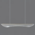 Clérachic linear pendant light in clear acrylic with a thin gold edge strip, hanging on two cables against a grey backdrop.