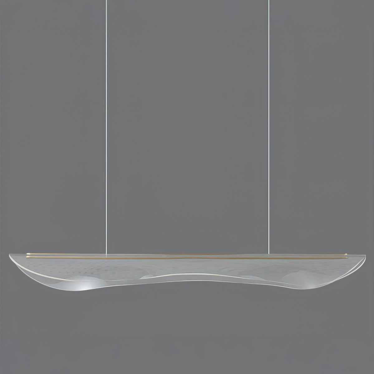 Clérachic linear pendant light in clear acrylic with a thin gold edge strip, hanging on two cables against a grey backdrop.