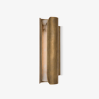 Clérachic wall sconce with two curved brass panels around a glowing alabaster slab, on a plain off-white backdrop.
