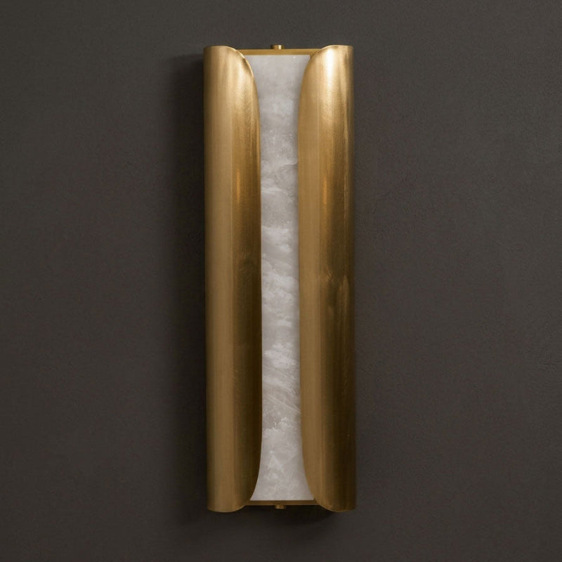 Front view of the unlit Clérachic wall sconce, with two curved brass panels either side of a pale veined alabaster slab.