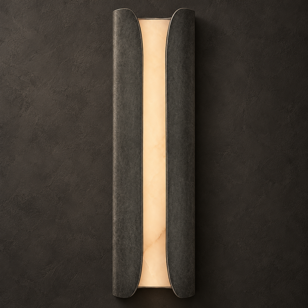 Clérachic alabaster sconce in a dark mottled pewter finish, its warm glowing stone slab framed by two curved panels.
