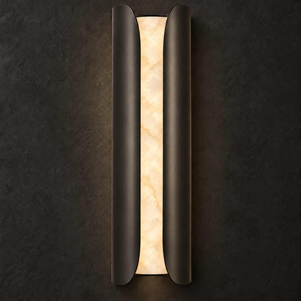 Black Clérachic alabaster wall sconce lit on a dark textured wall, the veining in the stone showing gold and cream.
