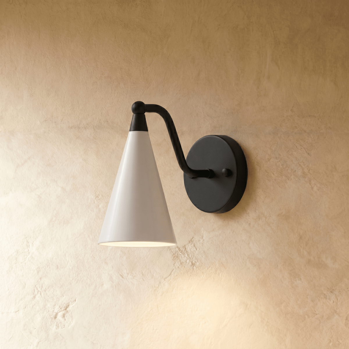 Clérachic cone-shade wall sconce in matte black with a white shade, mounted on a plaster wall in studio light.