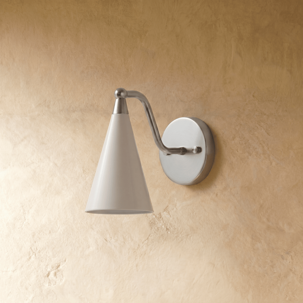 Clérachic cone-shade wall sconce in satin chrome, shown from a slightly closer studio angle on a plaster wall.