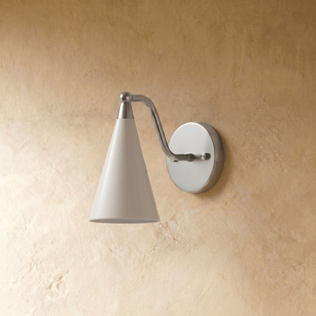 Clérachic cone-shade wall sconce in satin chrome, shown from a slightly closer studio angle on a plaster wall.
