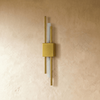 This gold-finish Clérachic wall light shows its square backplate and paired brass rods flanking the frosted acrylic strip.
