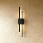 In matte black, this Clérachic wall sconce pairs slender rods with a glowing acrylic strip against a plastered wall.