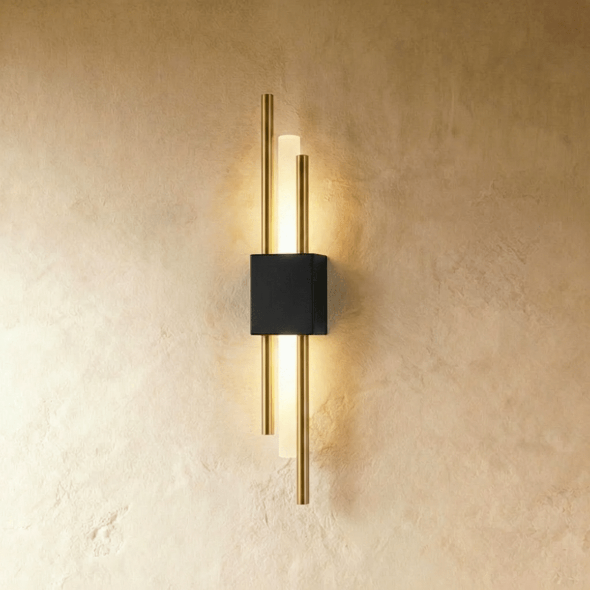 Seen from another angle, the black-and-gold Clérachic wall sconce frames its acrylic diffuser bar with brass rods.