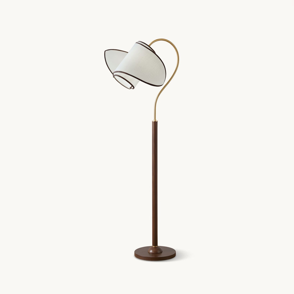 A Clérachic floor lamp with a walnut-colour stem and round base, a brass arc and a white fabric shade, on a plain white backdrop.