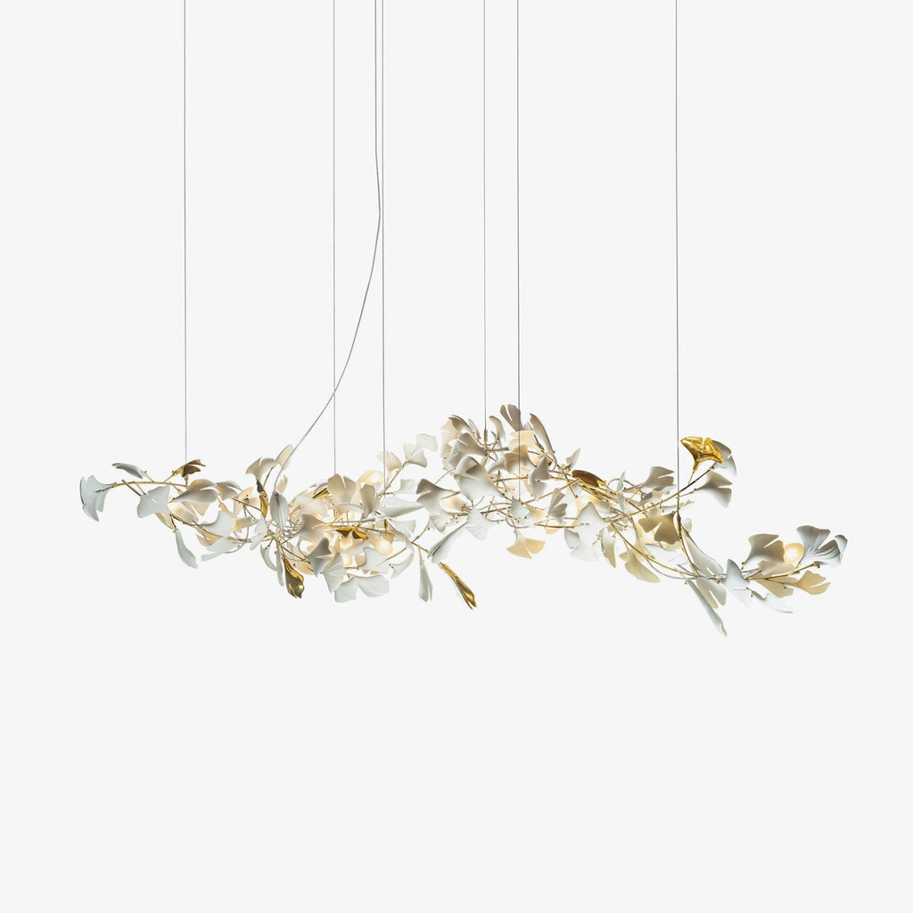 Clérachic gingko chandelier on white, porcelain and gilt leaves along a long branch frame.