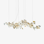 Clérachic gingko chandelier on white, porcelain and gilt leaves along a long branch frame.