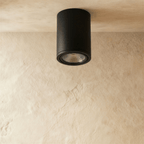 Clérachic black aluminium cylinder downlight, switched off, showing its ribbed reflector and slim trim ring on a ceiling.