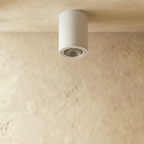 Clérachic compact white cylinder downlight, unlit, with its silver reflector and trim ring visible on a limewash ceiling.