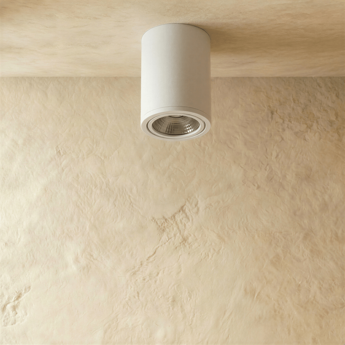 Clérachic compact white cylinder downlight, unlit, with its silver reflector and trim ring visible on a limewash ceiling.