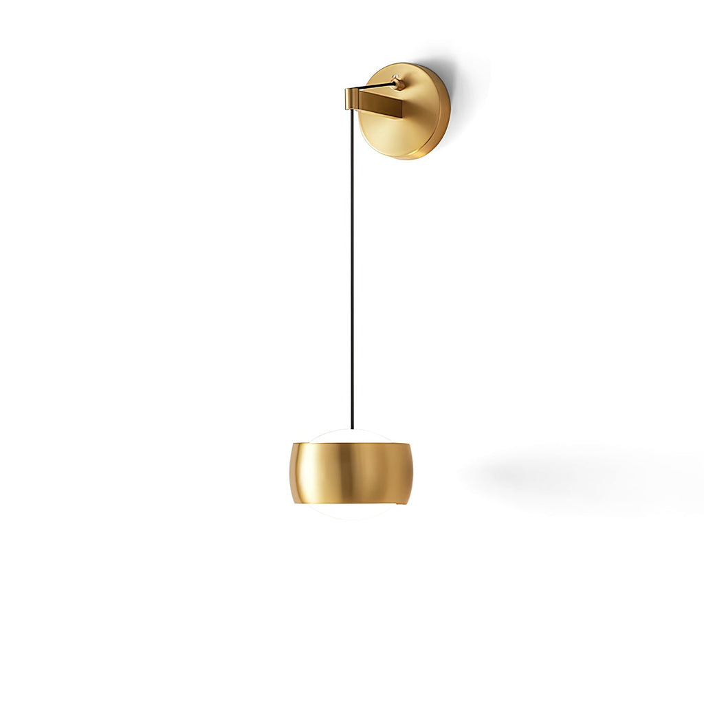 Brass Clérachic wall light on a white backdrop, the rounded shade hanging low below a brass backplate and black cable.