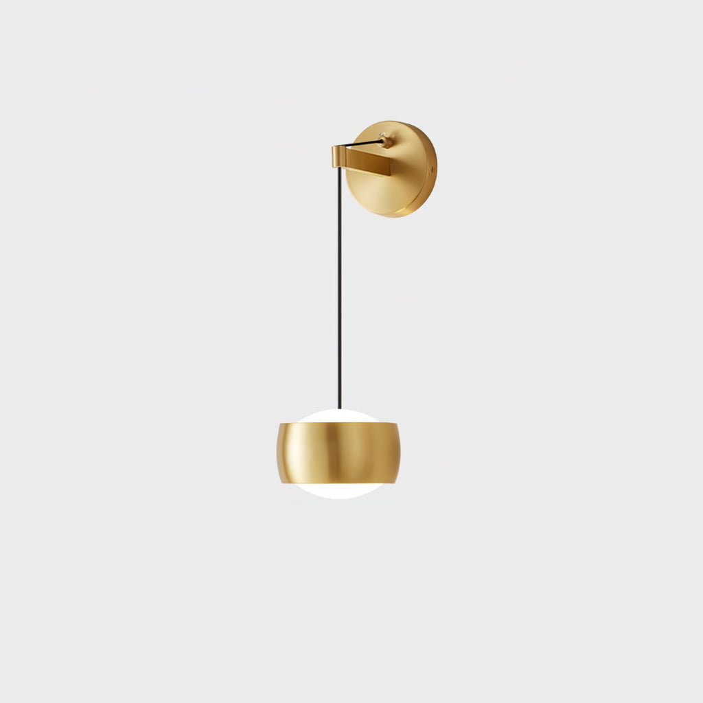 Brass Clérachic wall light on a pale grey backdrop, its rounded shade and white glass diffuser below a thin black cable.