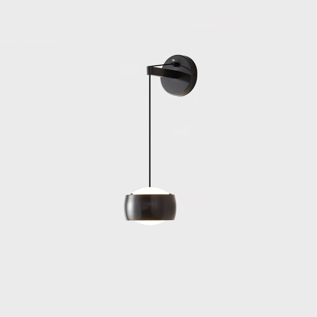 Black Clérachic wall light on a pale grey backdrop, its glossy cylinder shade with a white diffuser below a round backplate.