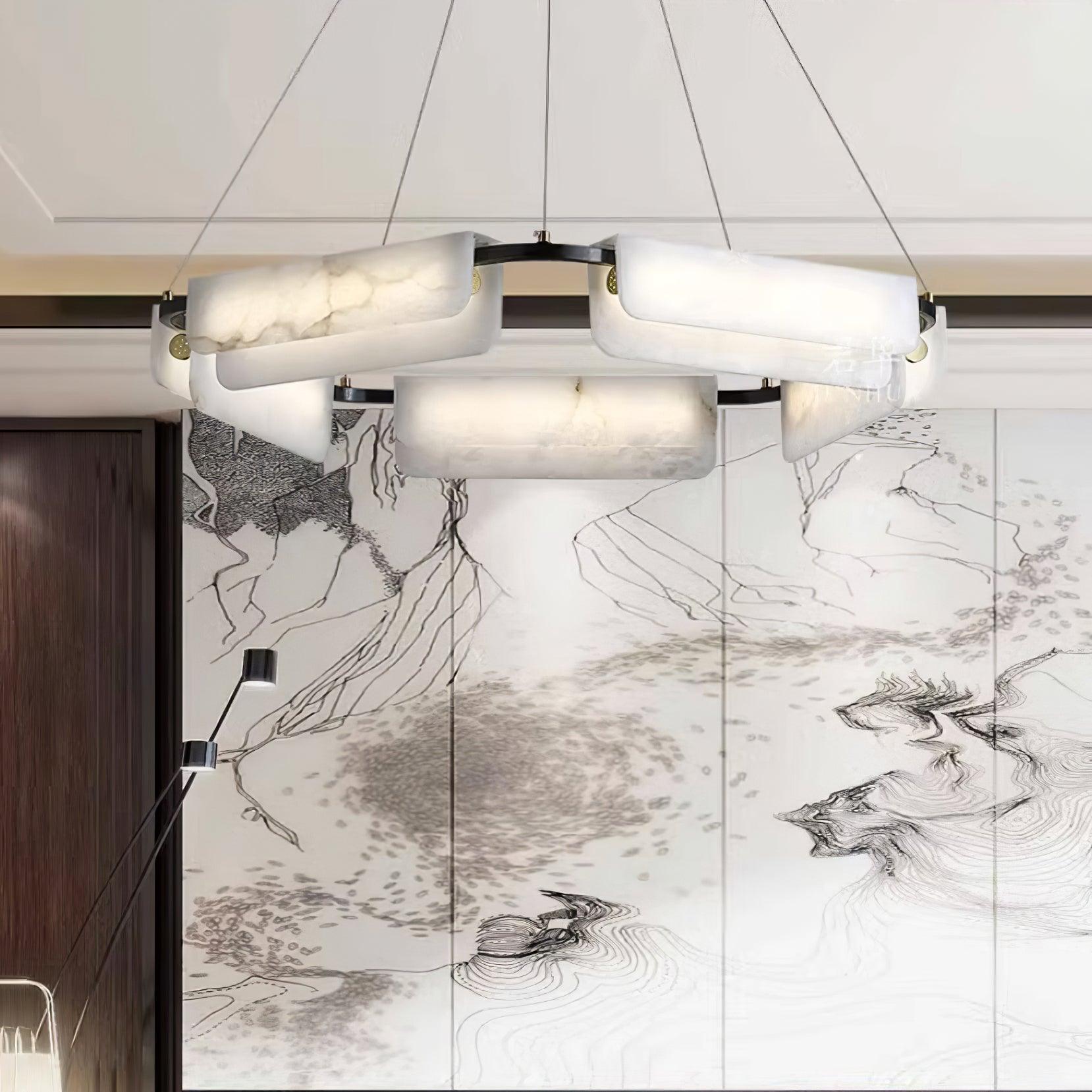 The Clérachic Delia chandelier lit in front of an ink-wash mountain screen and timber door.