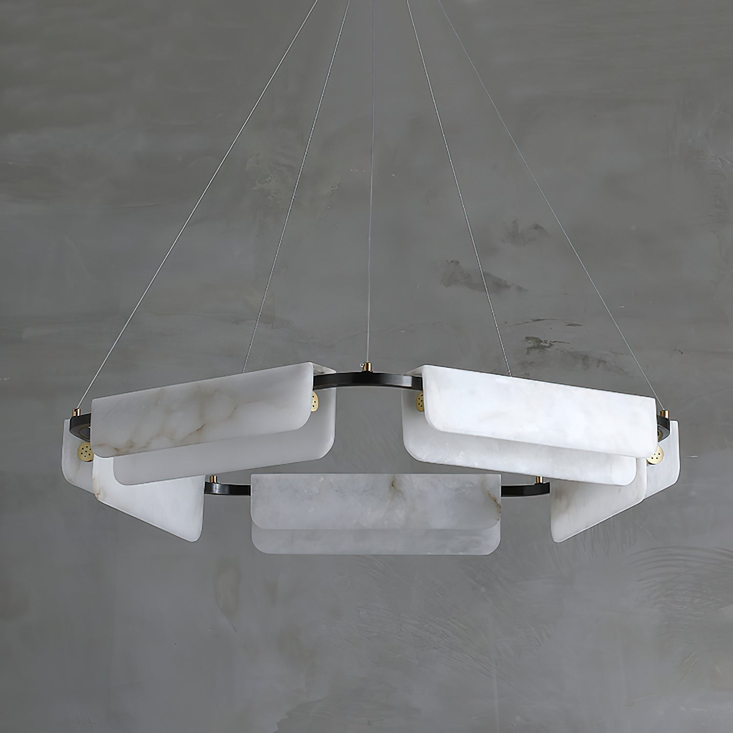 The five-head Clérachic Delia chandelier seen at an angle, alabaster panels stepped around the black ring.