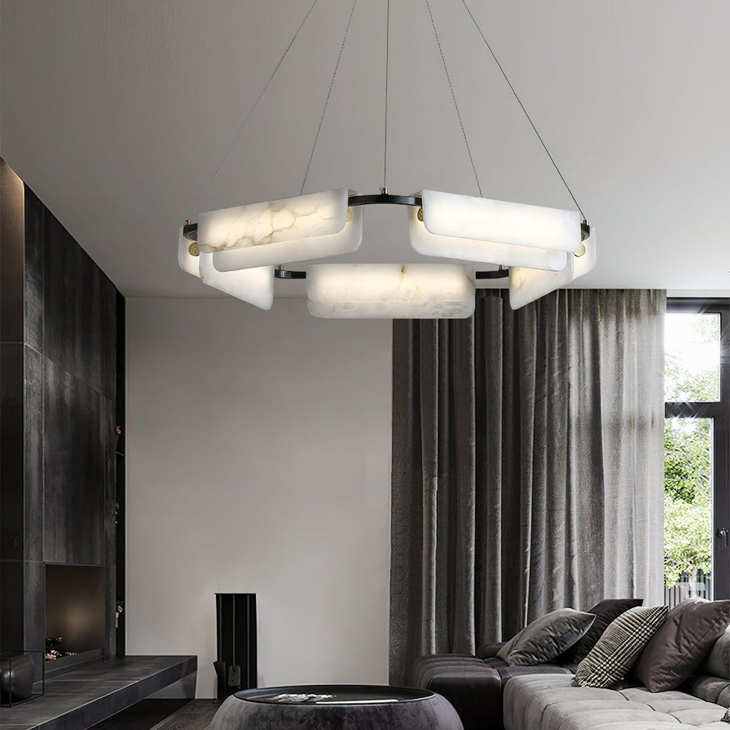 Clérachic Delia chandelier lit in a living room with floor-length curtains and a corner sofa.