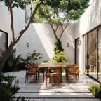 Four Clérachic black outdoor wall lamps on white courtyard walls around a teak dining table, seen in daylight