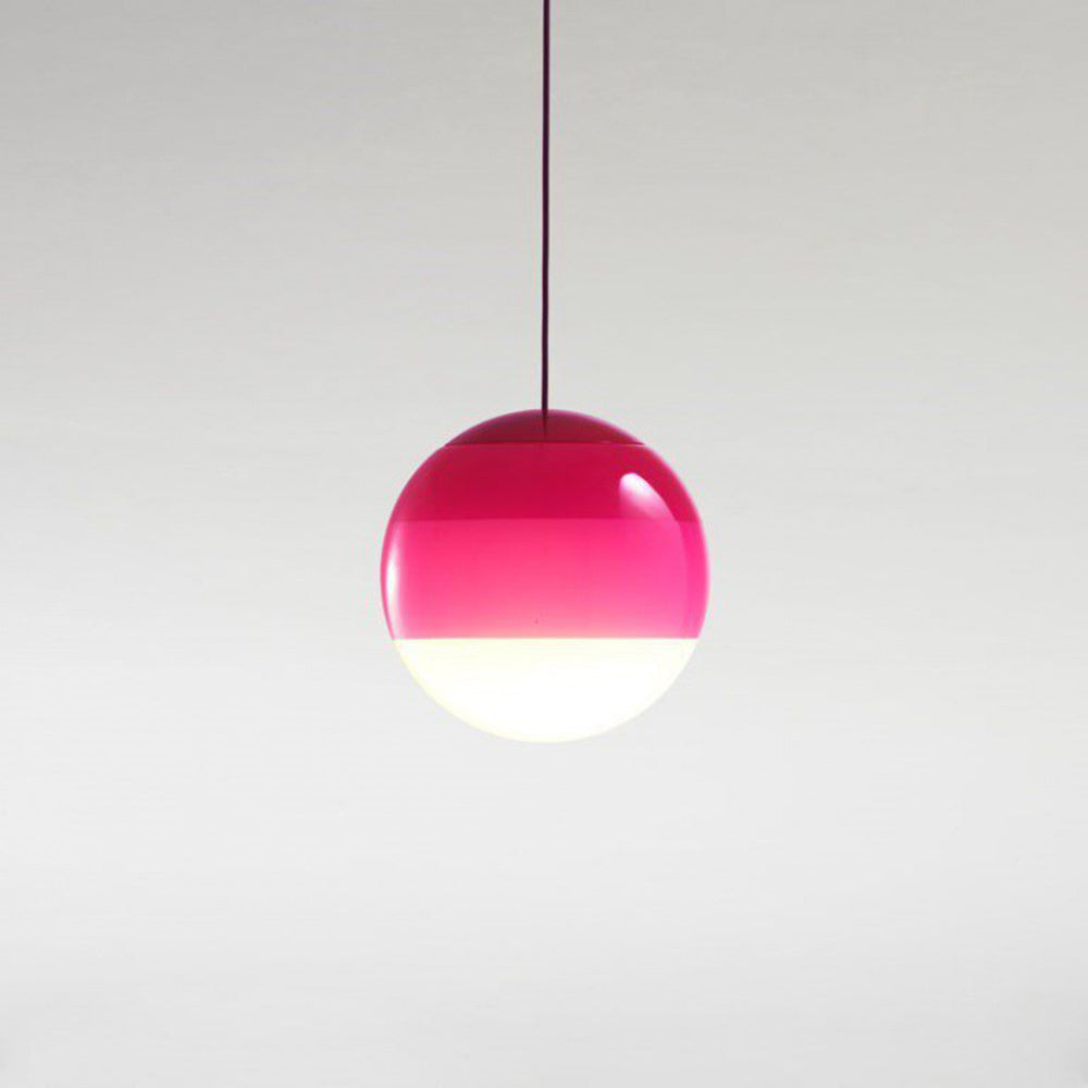 The magenta Clérachic dipped gradient glass pendant light on its colour-matched cord, shown against a plain grey backdrop.