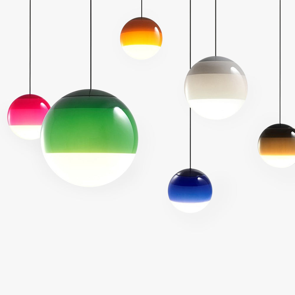 All six colours of the Clérachic dipped gradient glass pendant light hung at staggered heights against a white wall.