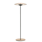 This Clérachic floor lamp on a plain white backdrop, with a wide disc shade on a slim black stem and a wood-grain base.