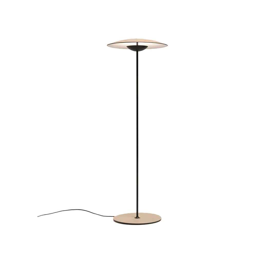 A Clérachic floor lamp with a wood-grain disc shade and round base on a white backdrop, its thin cord coiling to the left.