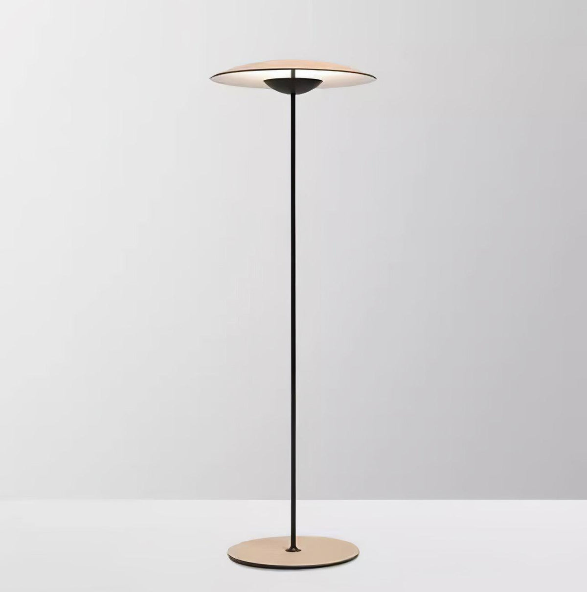 Front view of this Clérachic floor lamp against a soft grey backdrop, its shade lit from underneath and its base wood grain.