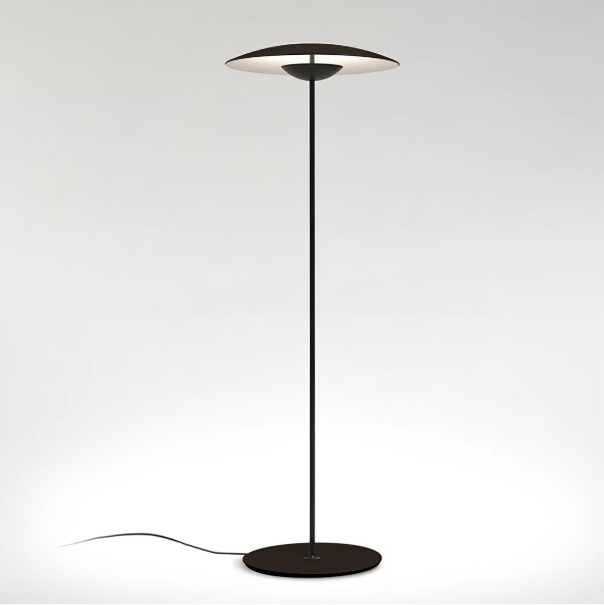 A matte black Clérachic floor lamp on a light grey backdrop, with a dark shade, black stem and round black base.