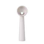 Clérachic floor lamp in a taupe version, with a textured tapering stem and a round white bulb in the bowl, on white.