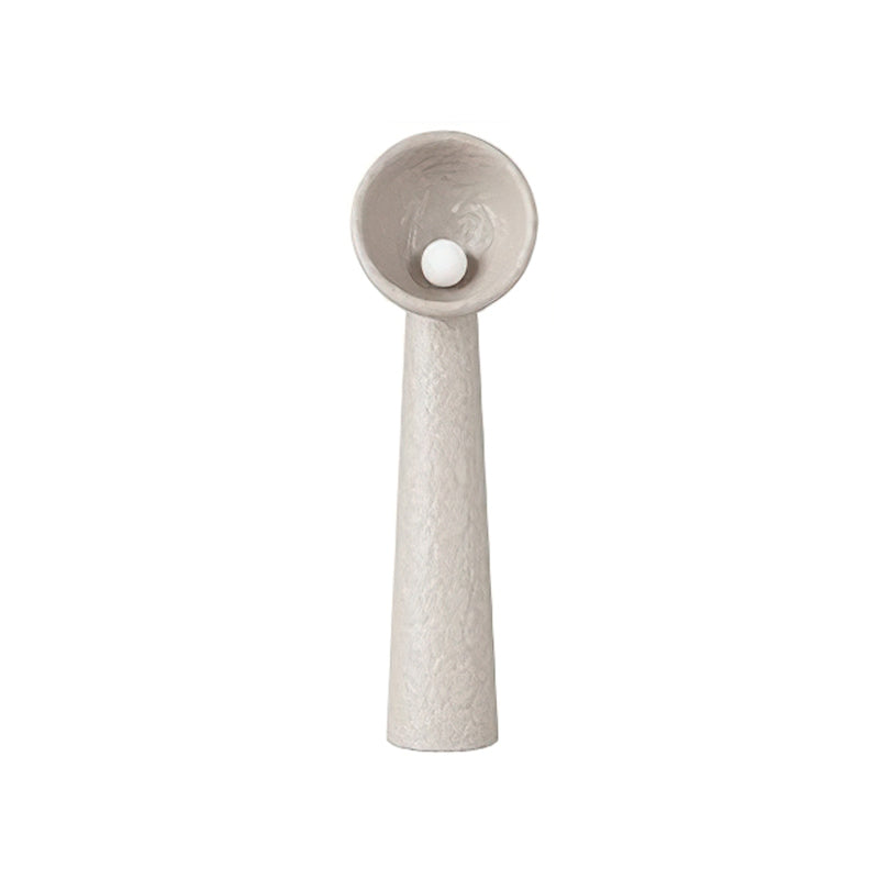 Clérachic floor lamp in a taupe-grey version, with a tall tapering stem and a round white bulb inside the bowl shade.