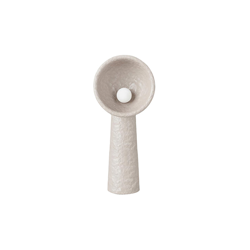 Shorter Clérachic floor lamp in a taupe tone, with a rough textured stem and a round bulb in the bowl, on white.