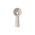 Shorter Clérachic floor lamp in a taupe tone, with a rough textured stem and a round bulb in the bowl, on white.