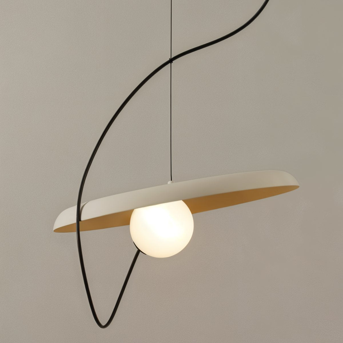 Clérachic pendant with a wide cream disc, a soft gold inner face and a glowing opal globe on a looping black cord.