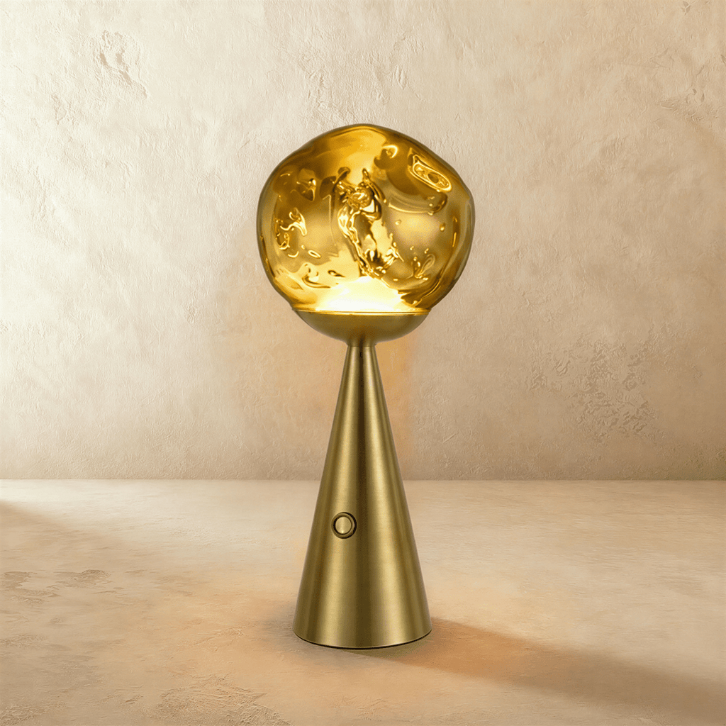 Clérachic gold table lamp with a rippled glass shade glowing warm above a brushed brass conical base and touch button.