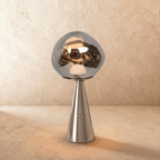 Clérachic chrome silver table lamp with a mirrored, distorted glass shade on a polished stainless steel conical base.